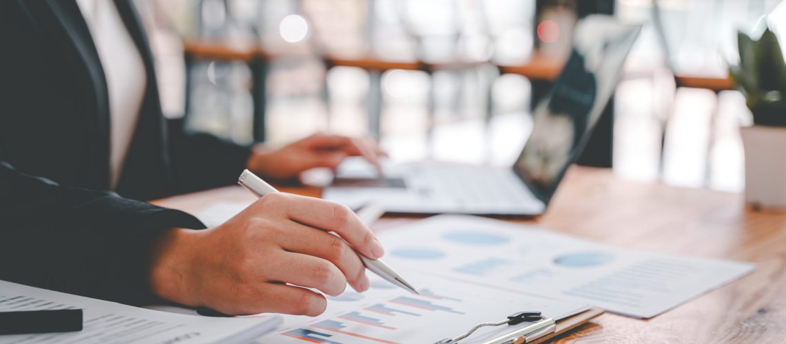 Portrait of a woman working on a tablet computer in a modern office. Make an account analysis report. real estate investment information financial and tax system concepts